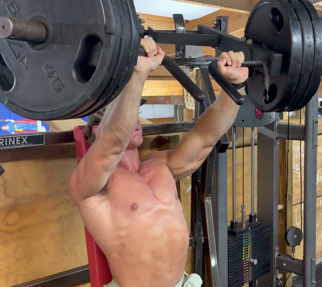 Cole locking out an incline machine press